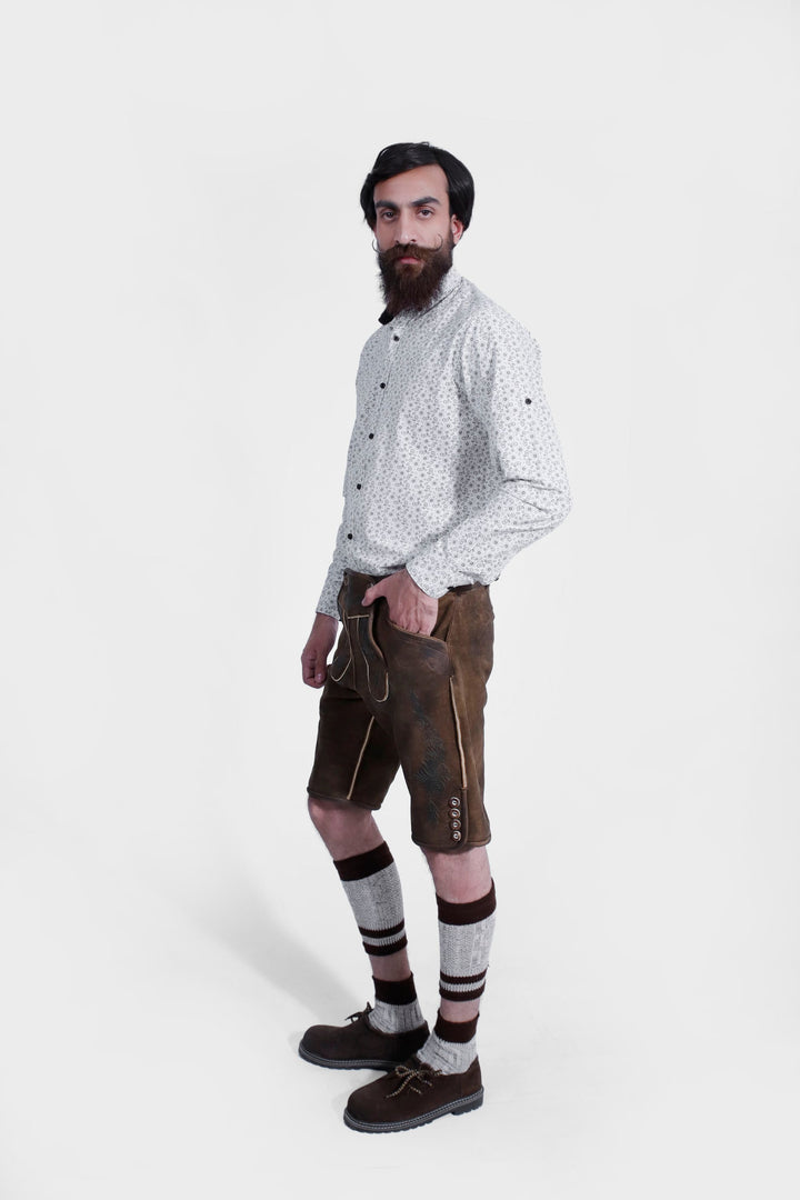 Brown leather lederhosen with intricate embroidery and button details, shown from a side view, worn by a man against a white background.