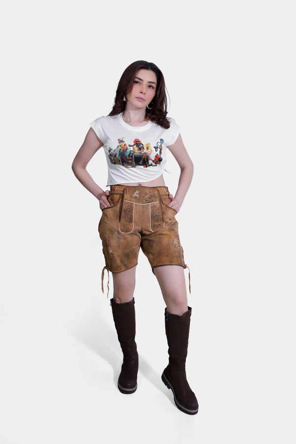 Stefani lederhosen for women,A woman modeling traditional Bavarian lederhosen in a warm brown hue named "Autumn Chestnut," detailed with intricate embroidery and paired with a casual graphic t-shirt. Frauen Lederhose Tracht 