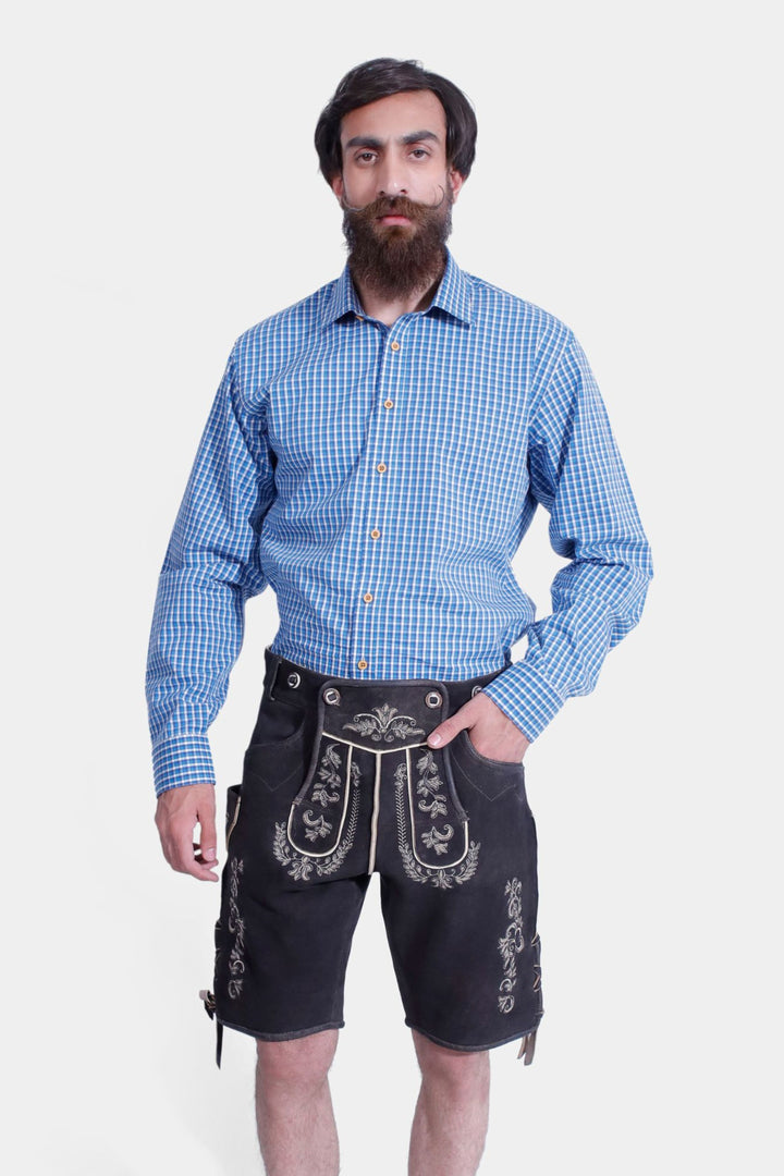 Front view of a man wearing Versailles Lederhosen with hands in pockets, highlighting the intricate embroidery and traditional Bavarian design.