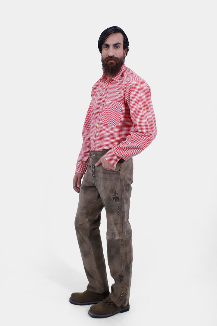 Profile view of a person wearing Wachau Valley Lederhosen Long Pant with detailed embroidery, paired with a red and white checkered shirt.