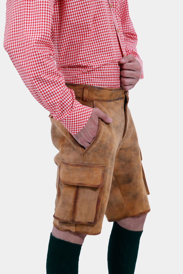 Detailed side view of a man wearing Wagner Cargo Lederhosen, focusing on the pockets and craftsmanship of the light brown leather shorts.