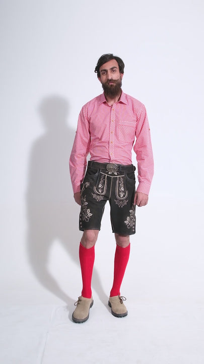 Video showing a 360-degree view of the Everglades Lederhosen Outfit worn by a man in a red checkered shirt, red socks, and beige-colored shoes, highlighting the detailed craftsmanship, embroidery, and features of the traditional Bavarian leather shorts.