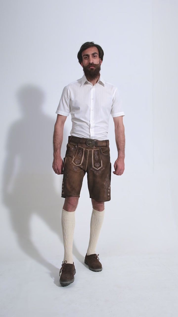 Man showcasing Richard Strauss Lederhosen, rotating to display all angles of the outfit, including front, side, and back views.