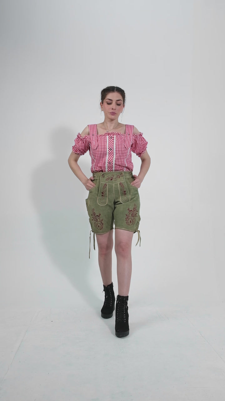 Showcase video of the Olivia Charm Lederhosen, highlighting the product's detailed craftsmanship, rich suede texture, and stylish embroidery through various model poses and close-up shots.