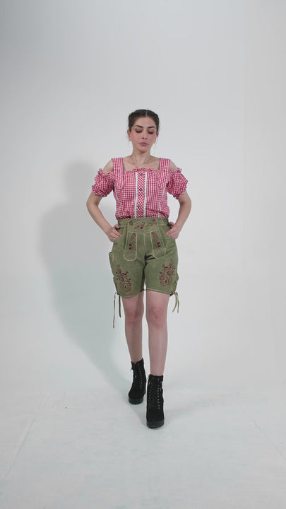 Showcase video of the Olivia Charm Lederhosen, highlighting the product's detailed craftsmanship, rich suede texture, and stylish embroidery through various model poses and close-up shots.