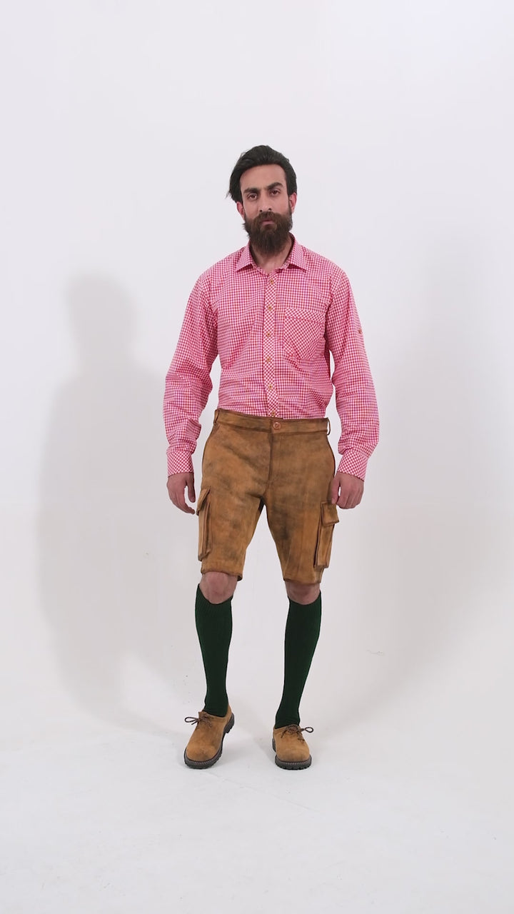 Video showing a 360-degree view of the Wagner Cargo Lederhosen worn by a man, highlighting the detailed craftsmanship, fit, and features of the traditional Bavarian leather shorts.