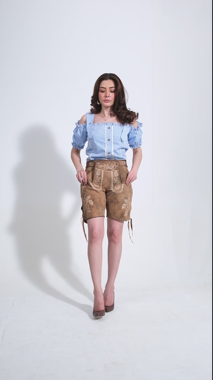 Video showcasing Lorelei Lederhosen: Luxurious goat suede leather shorts in Rustic Oak with intricate embroidery and stylish details.