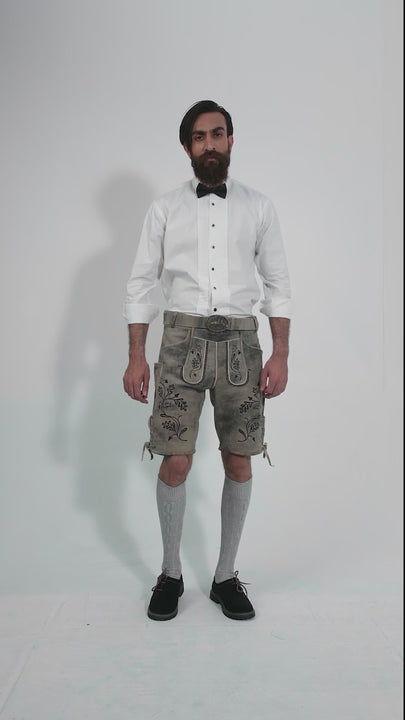 Man showcasing Hofburg Lederhosen, rotating to display all angles of the outfit, including front, side, and back views.